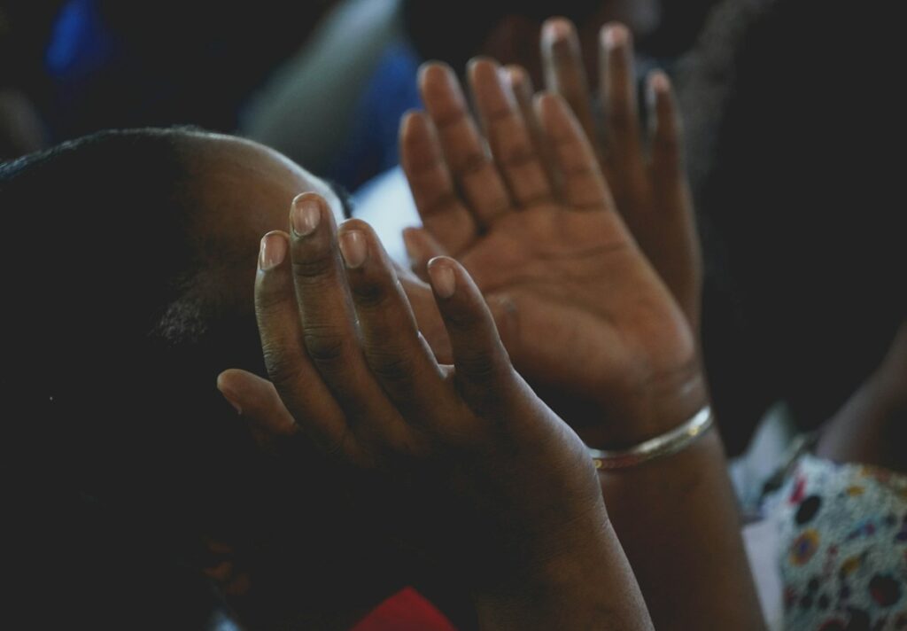Woman praying with raised hands